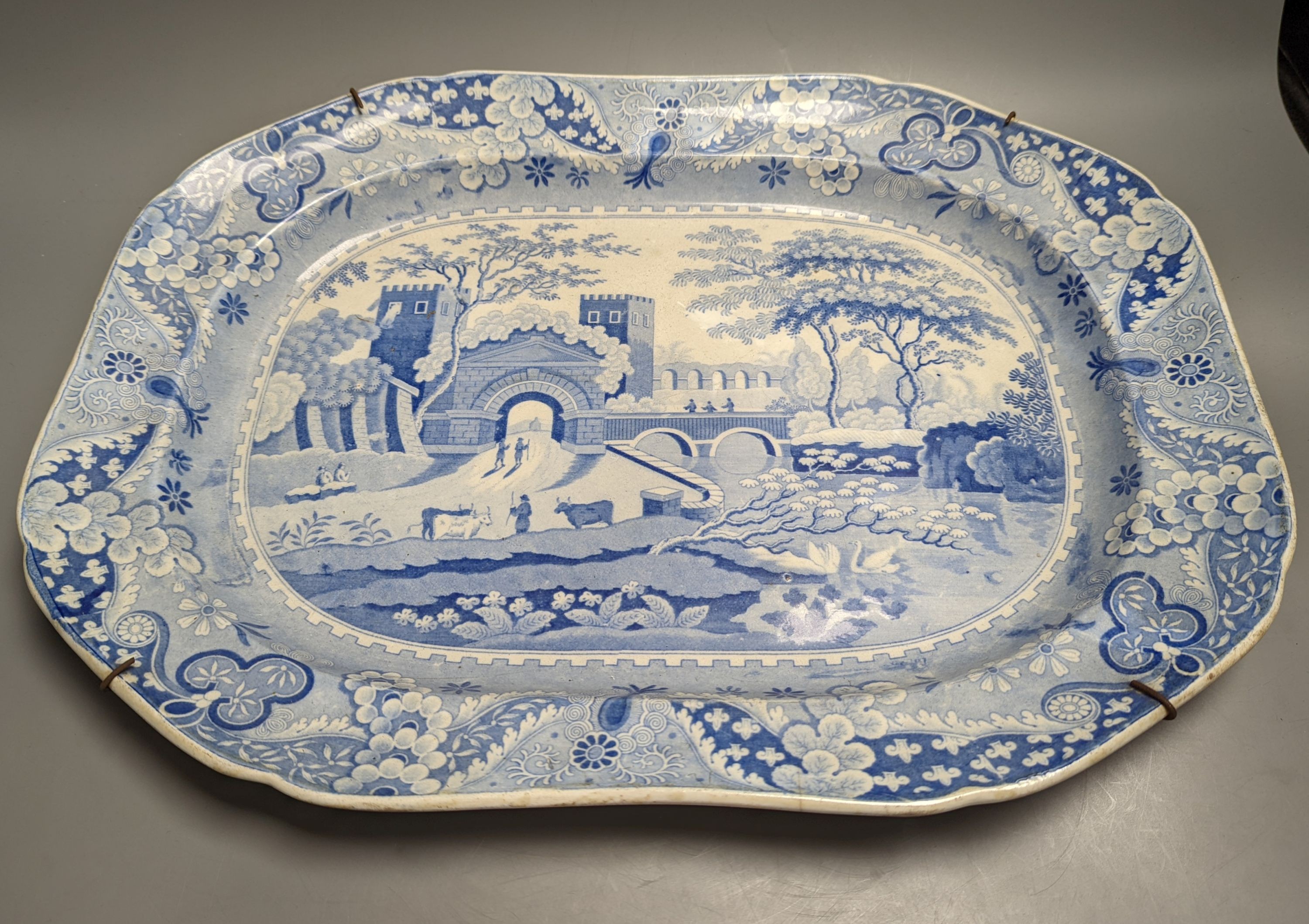 Two 19th century blue and white meat dishes and three similar plates, largest platter 49cms wide